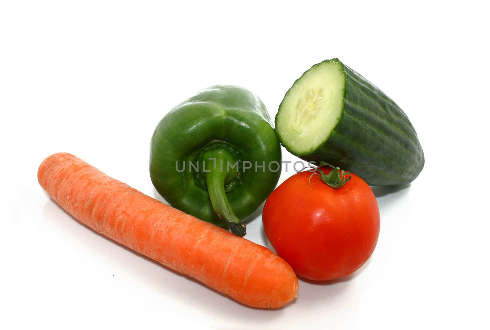 some vegetables, a carot, a paprika, a tomato, and a cucumber