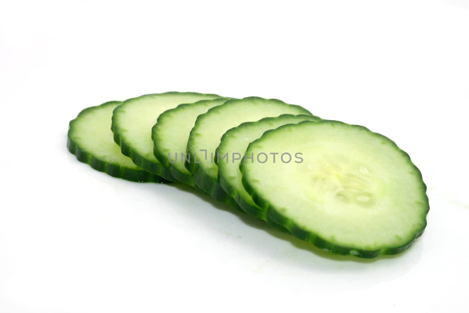 six green cut cucumber slices