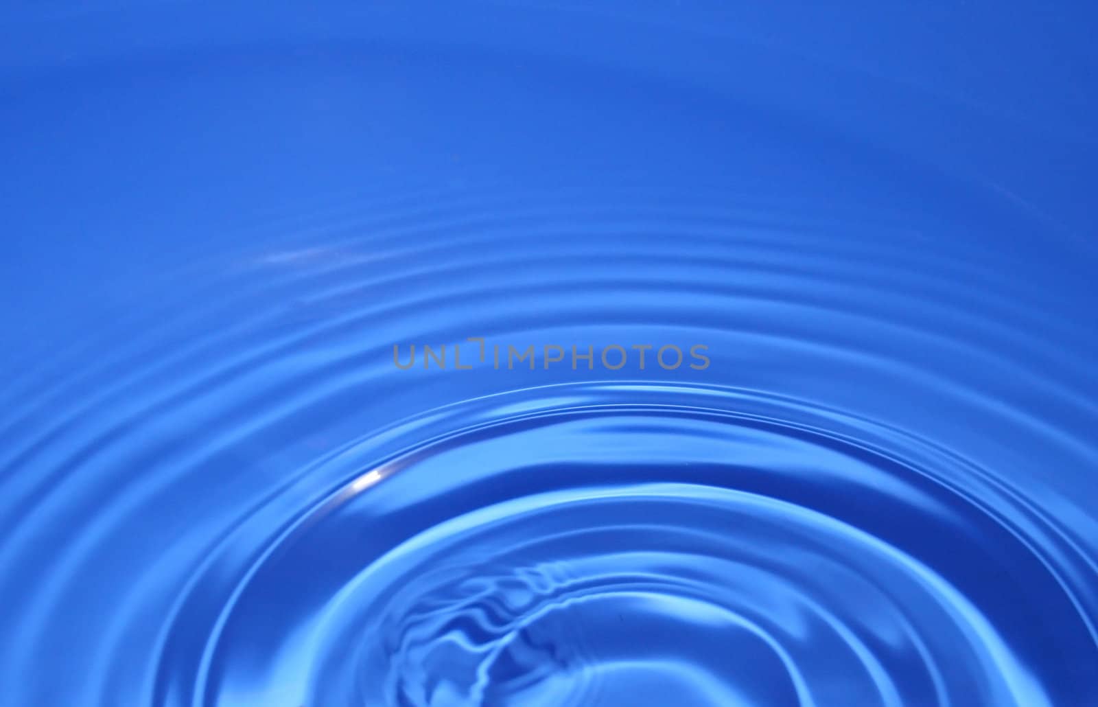 some blue water ripples after a drop of water