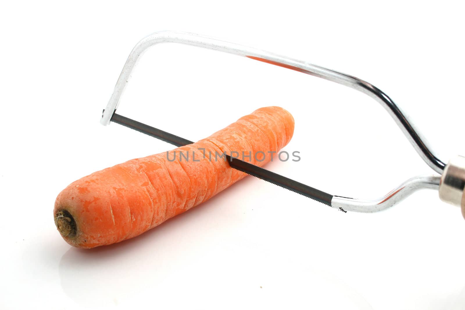 a carrot with a metal saw on white background