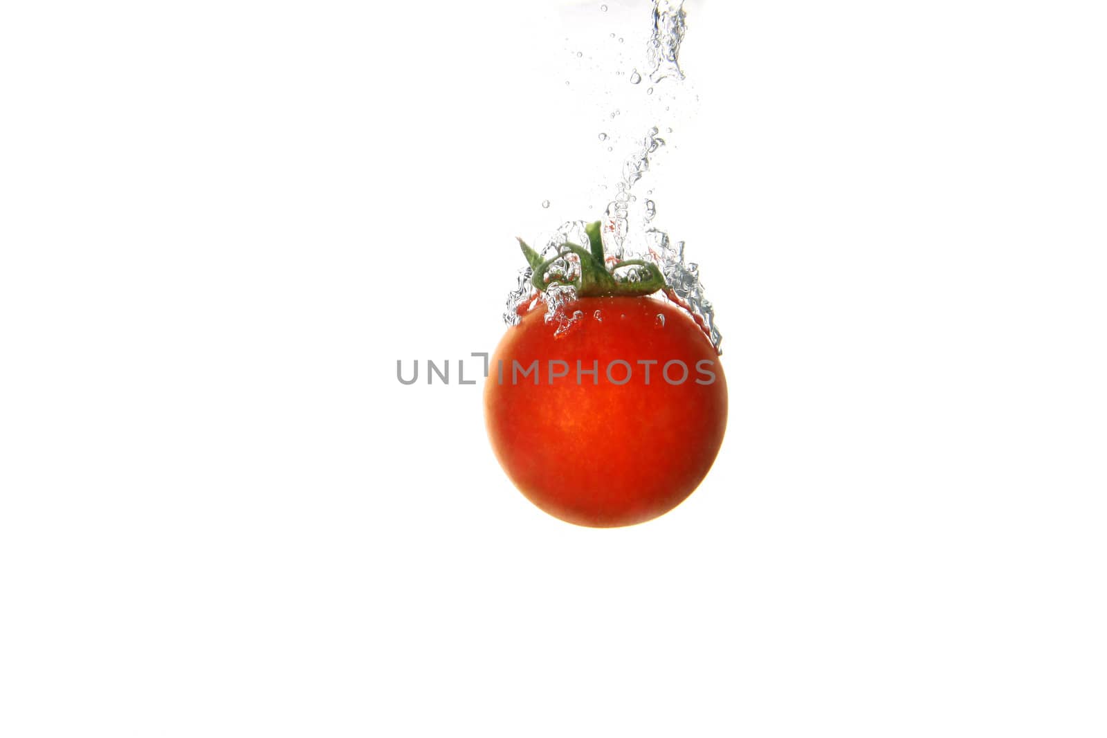 a tomato splashing into water