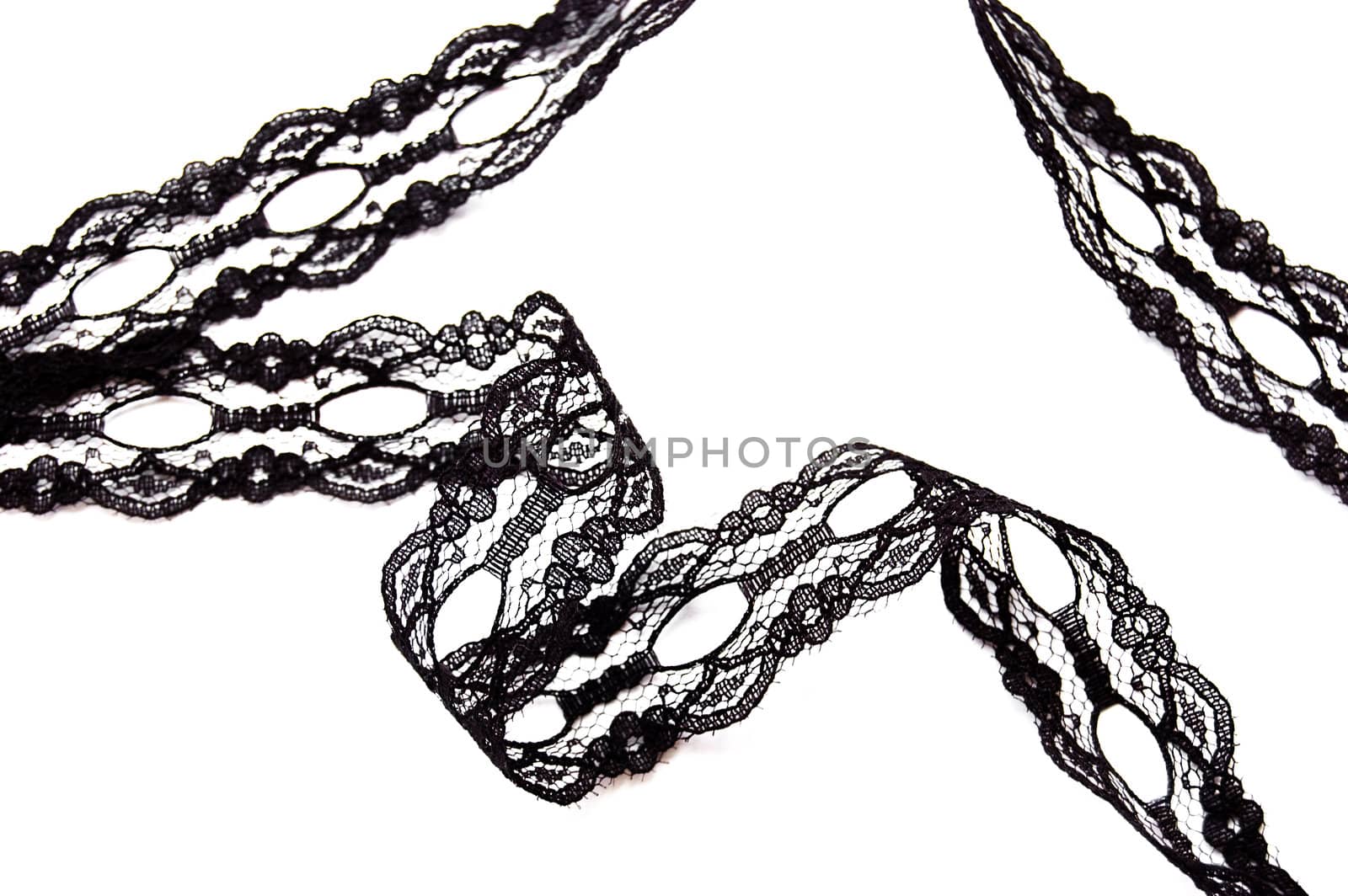 Black delicate lace on white background isolated