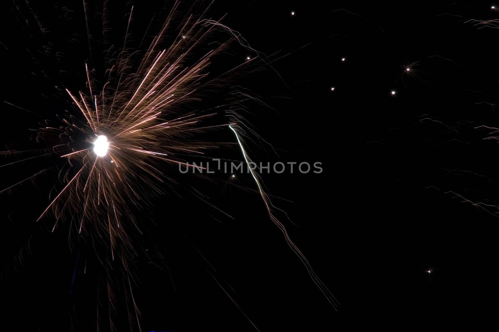 long exposure of multiple fireworks against a black sky  by ladyminnie