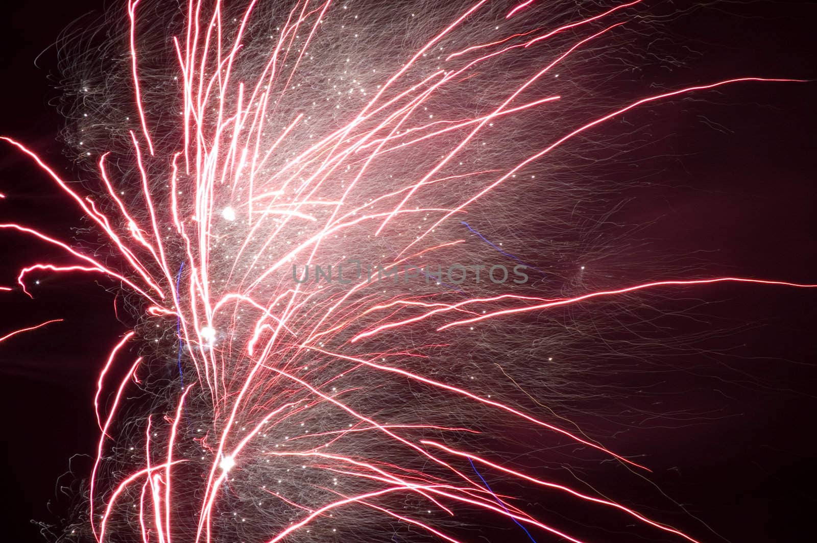 long exposure of multiple fireworks against a black sky by ladyminnie