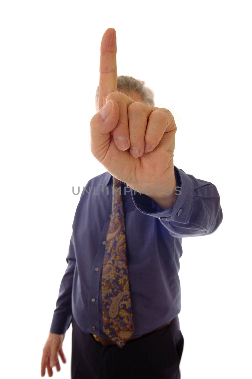 A senior businessman, in shirtsleeves, indicating 'one' with his finger. (Could also be a signal for 'quiet')