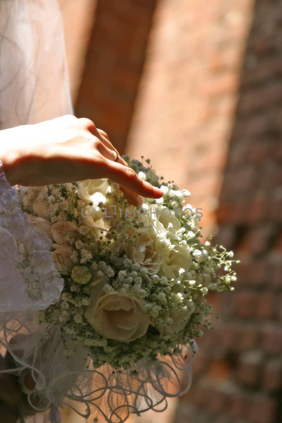 The bride holds a wedding bouquet