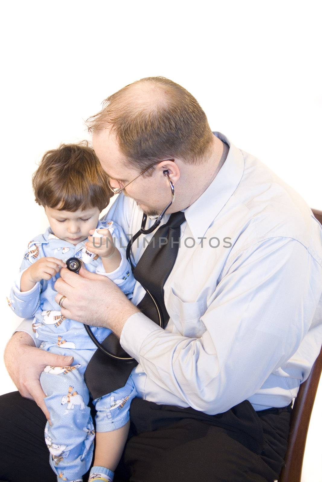 Doctor sitting with young child giving checkup