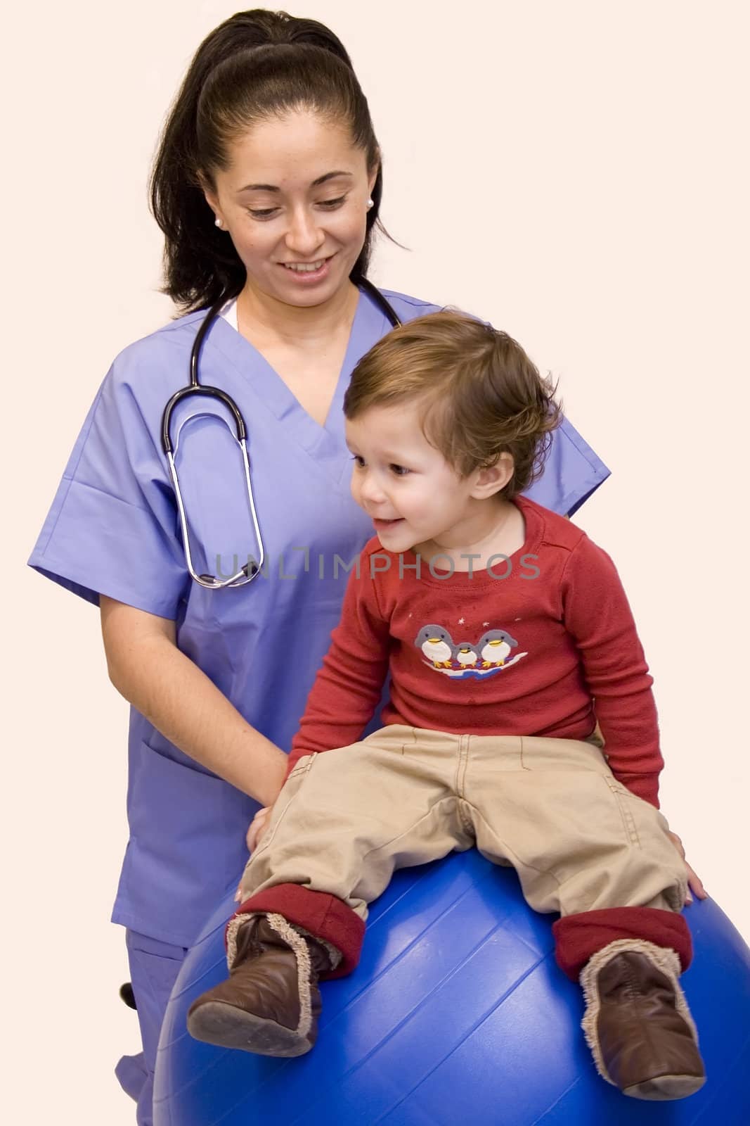 Pretty Hispanic nurse and young child isolated on white