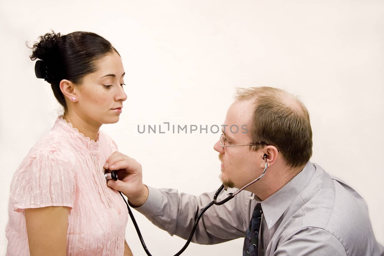 Doctor giving checkup to hispanic woman
