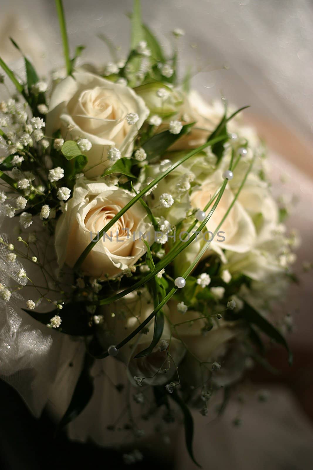 The bride holds a wedding bouquet