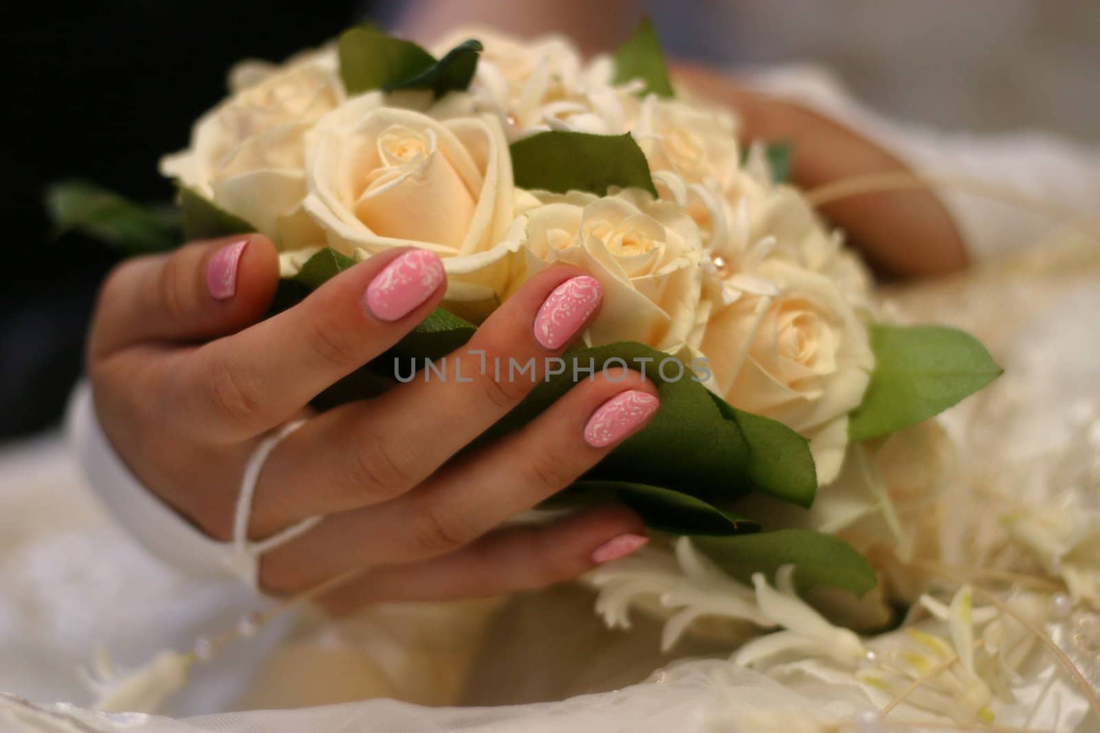 The bride holds a wedding bouquet