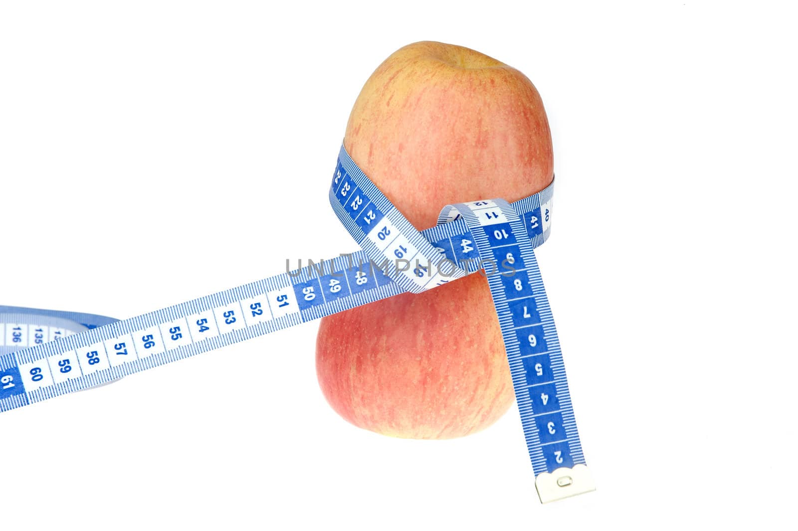 closeup of an apple with a  centimeter on white background