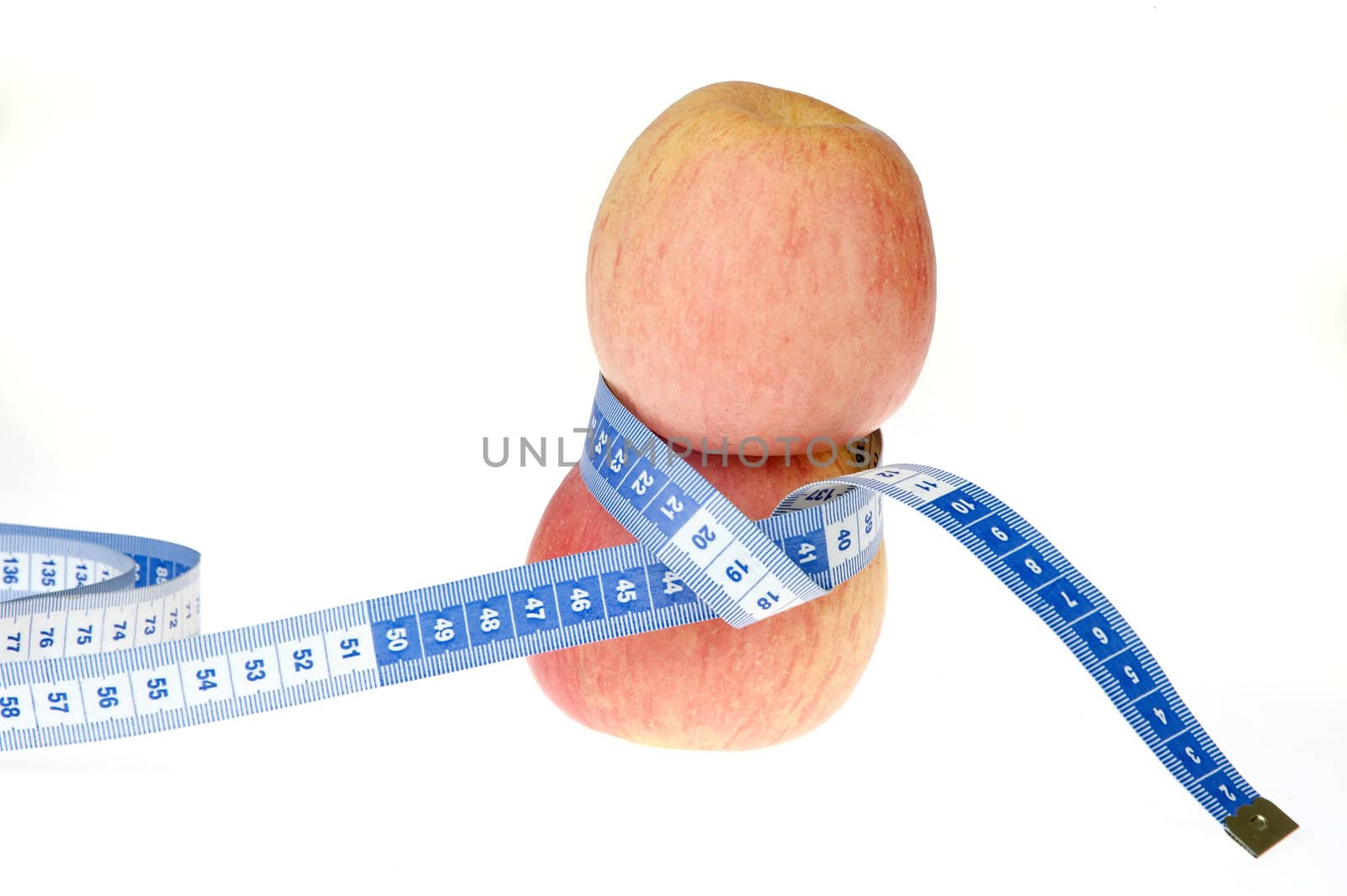 closeup of an apple with a  centimeter on white background