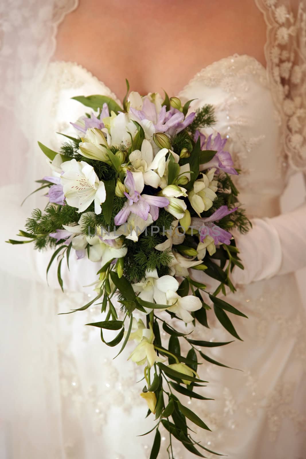 The bride holds a wedding bouquet