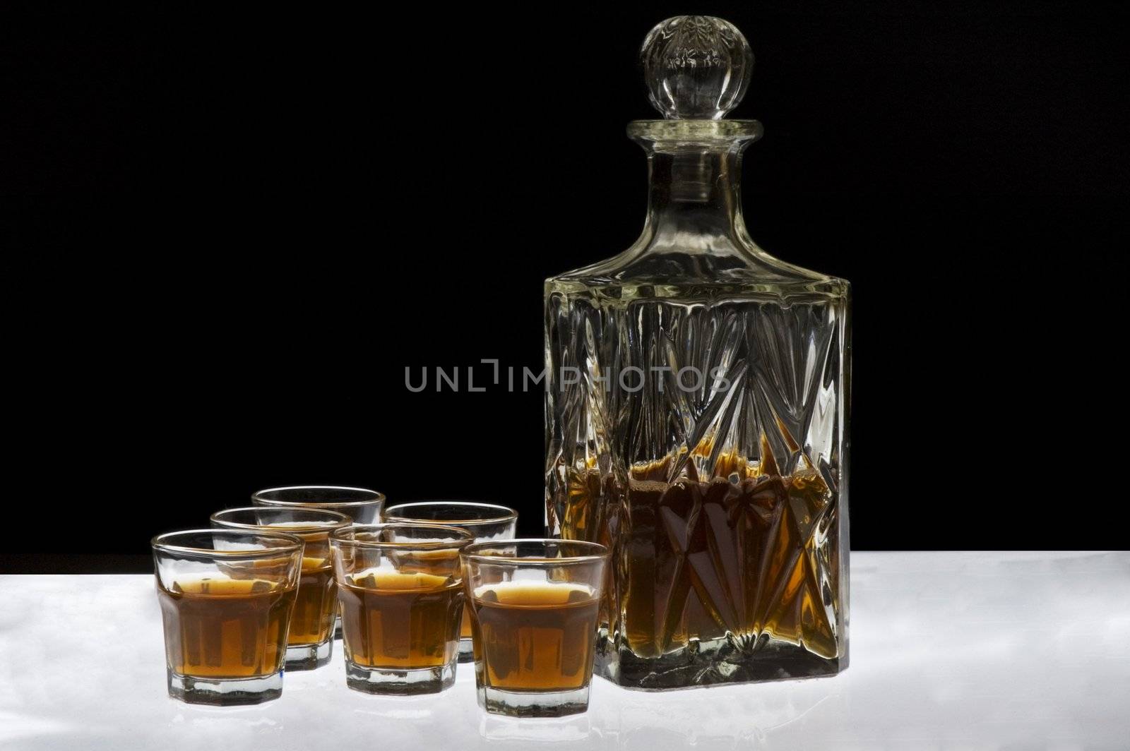 Glass of whisky isolated over white and black background