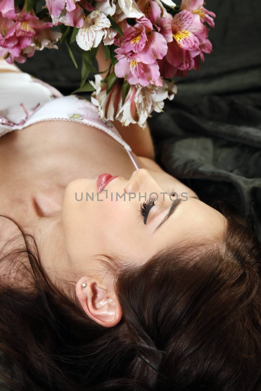 Beautiful nude woman covered with bouquet