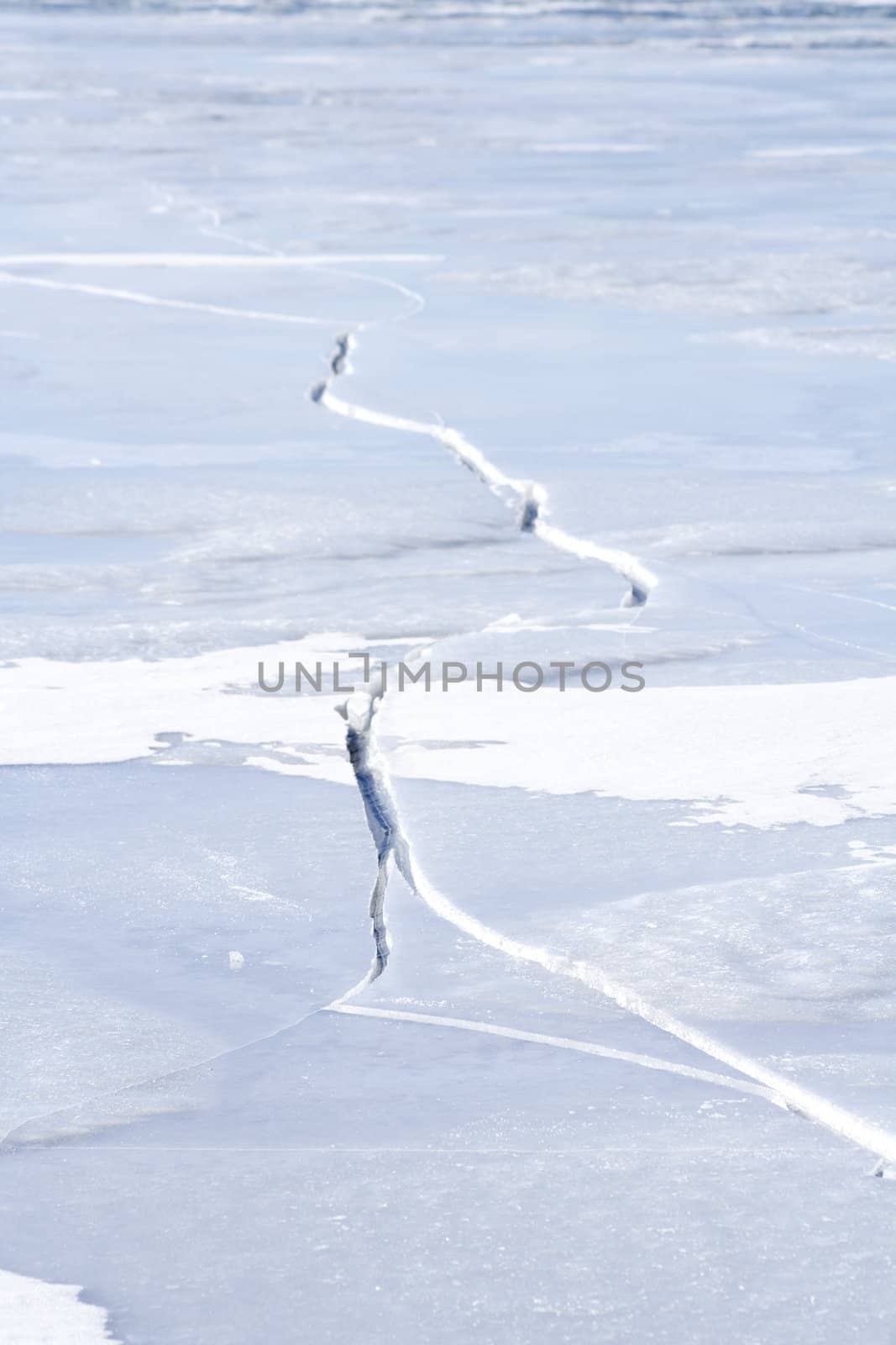 Large crack on ice on a frozen lake