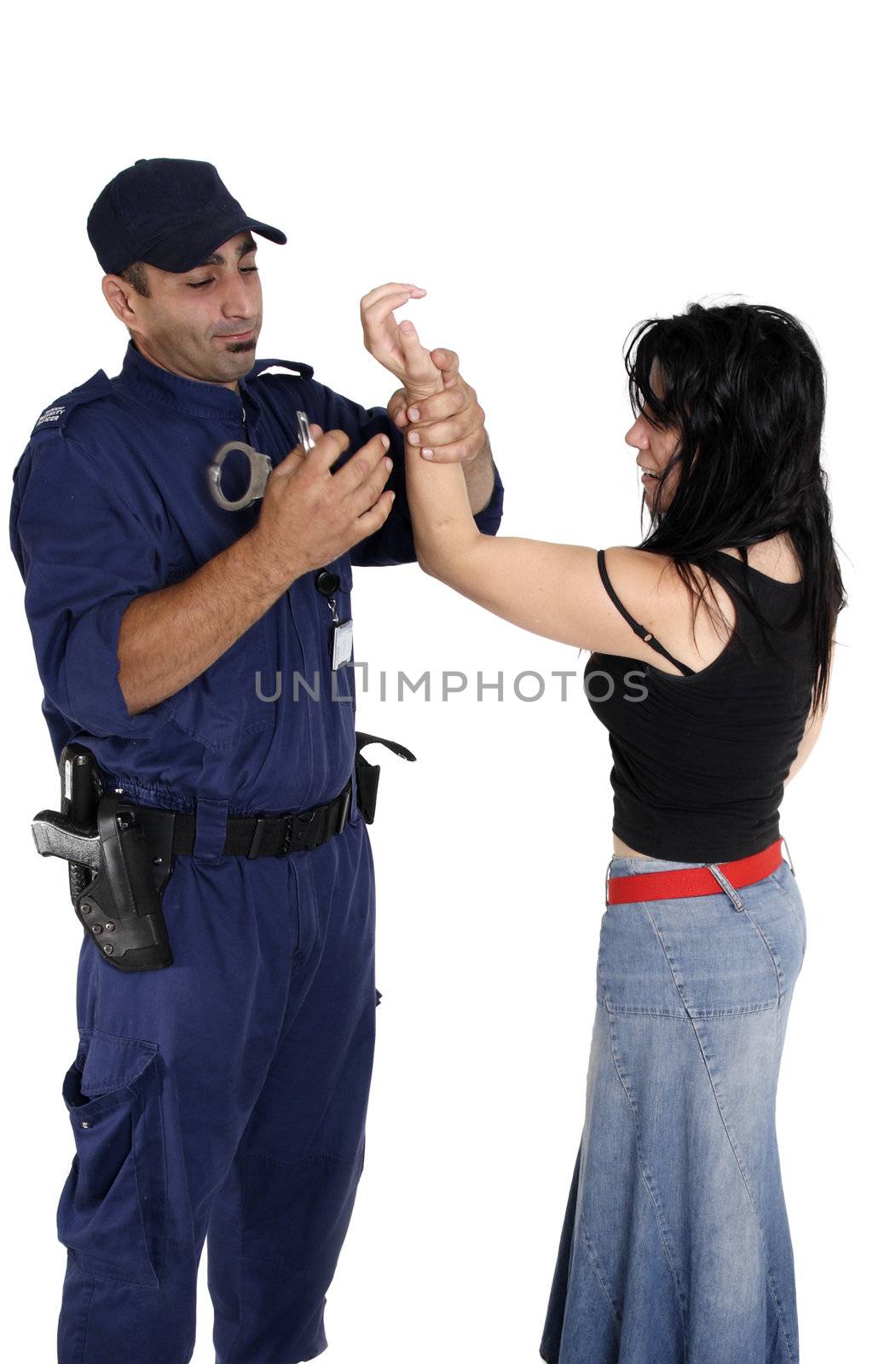 A male security officer handcuffs a female.  Cuffs show motion.