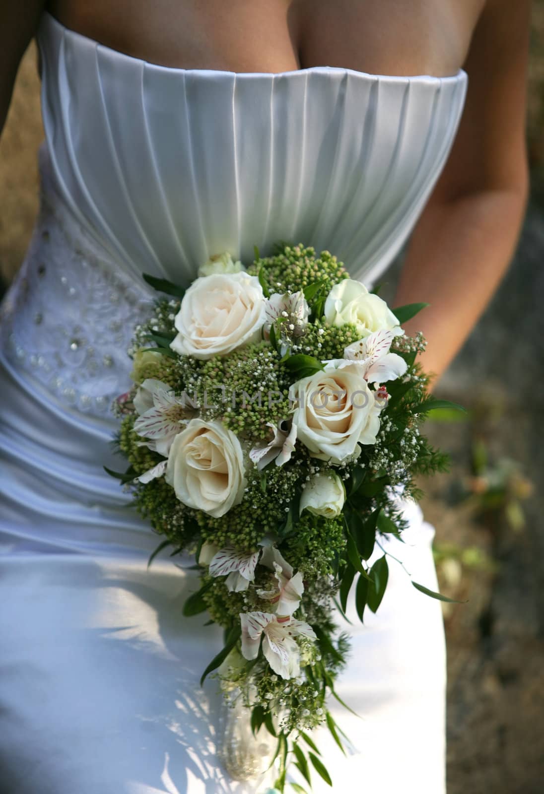 The bride holds a wedding bouquet