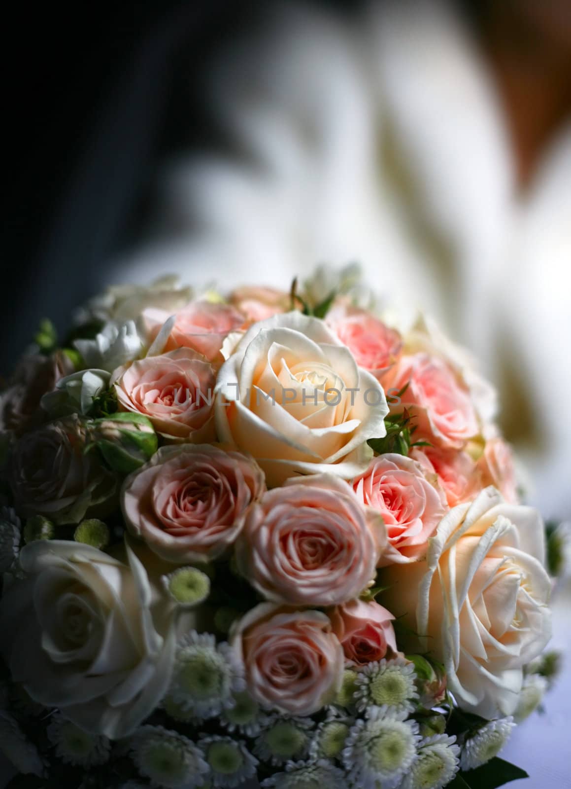 The bride holds a wedding bouquet