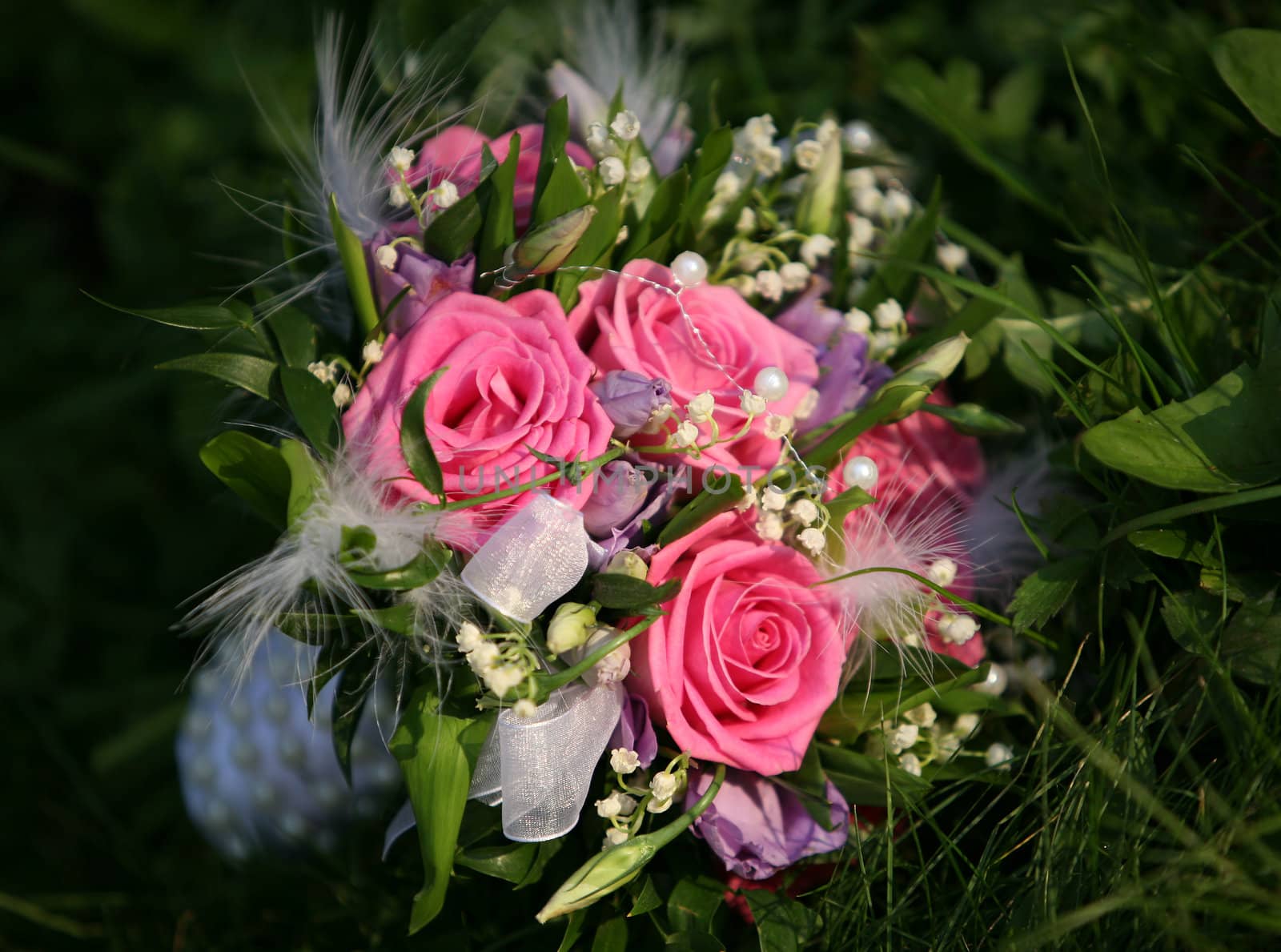Wedding bouquet from roses in a grass