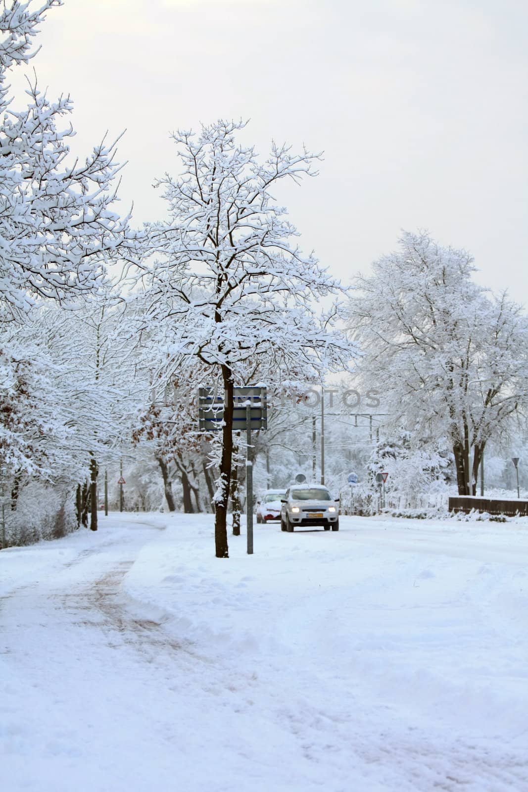 Cars driving very slow on a frozen country road