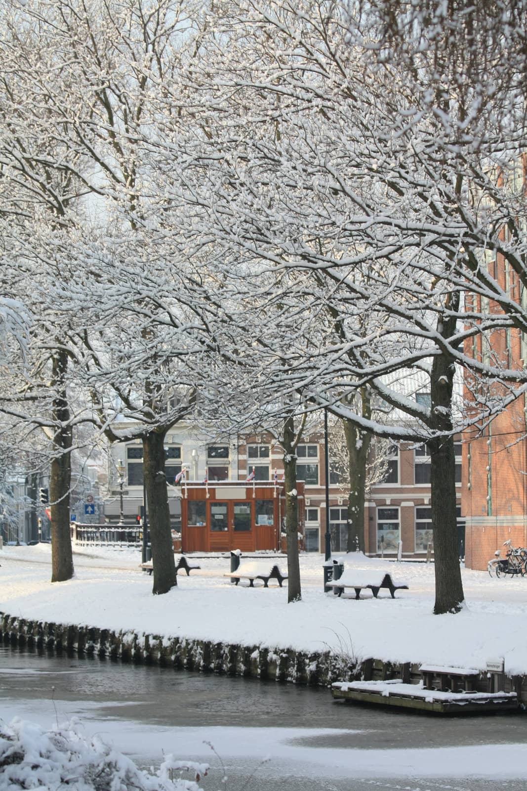 A canal and a small fish kiosk in a winter city