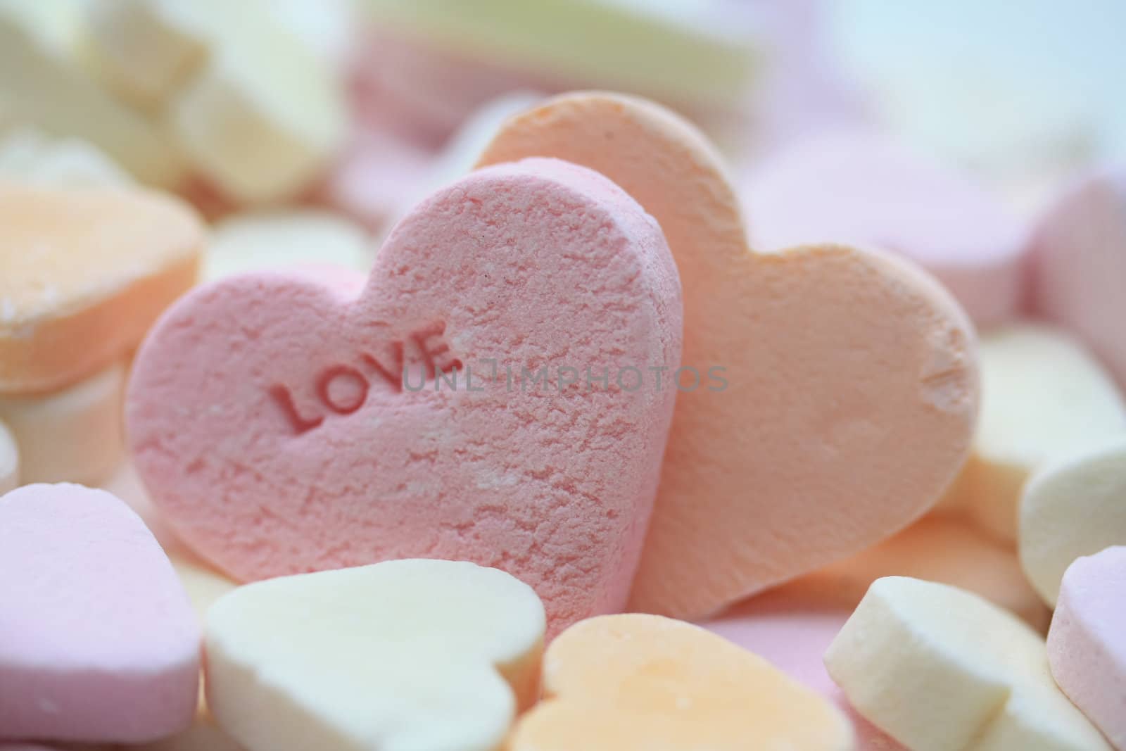 Valentine candy heart with the word love, in pink