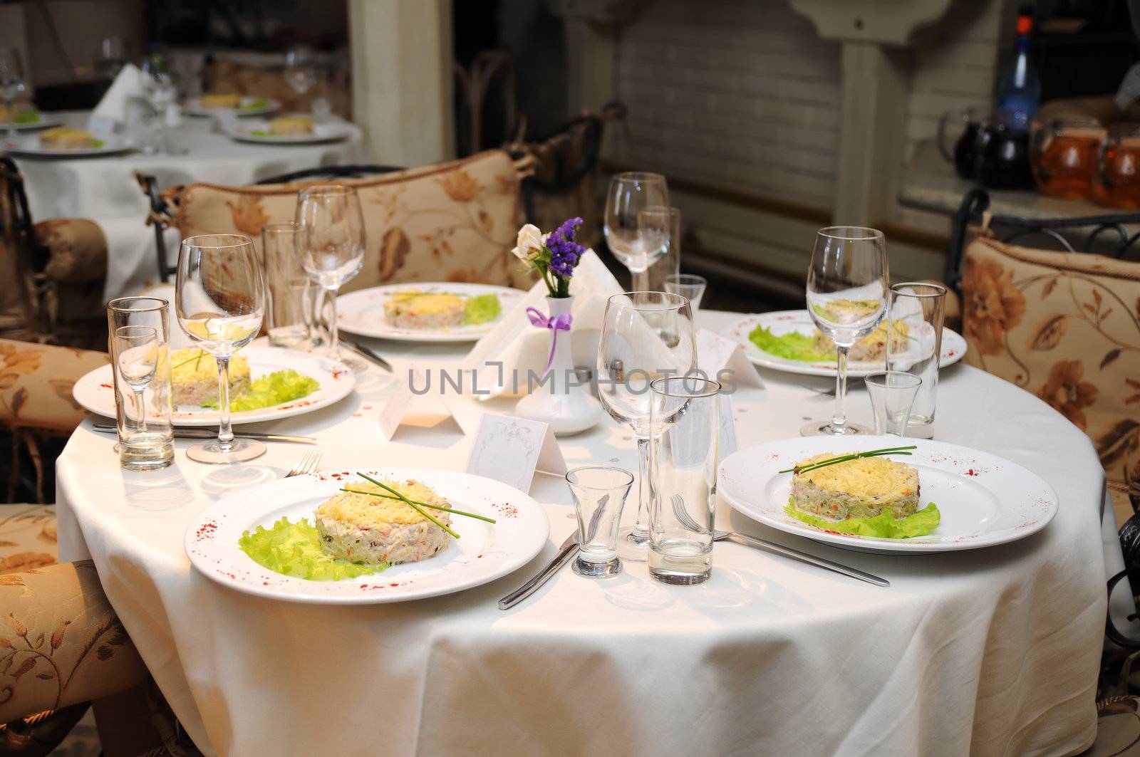 Wedding table with decoration in fine restaurant with food served in plates