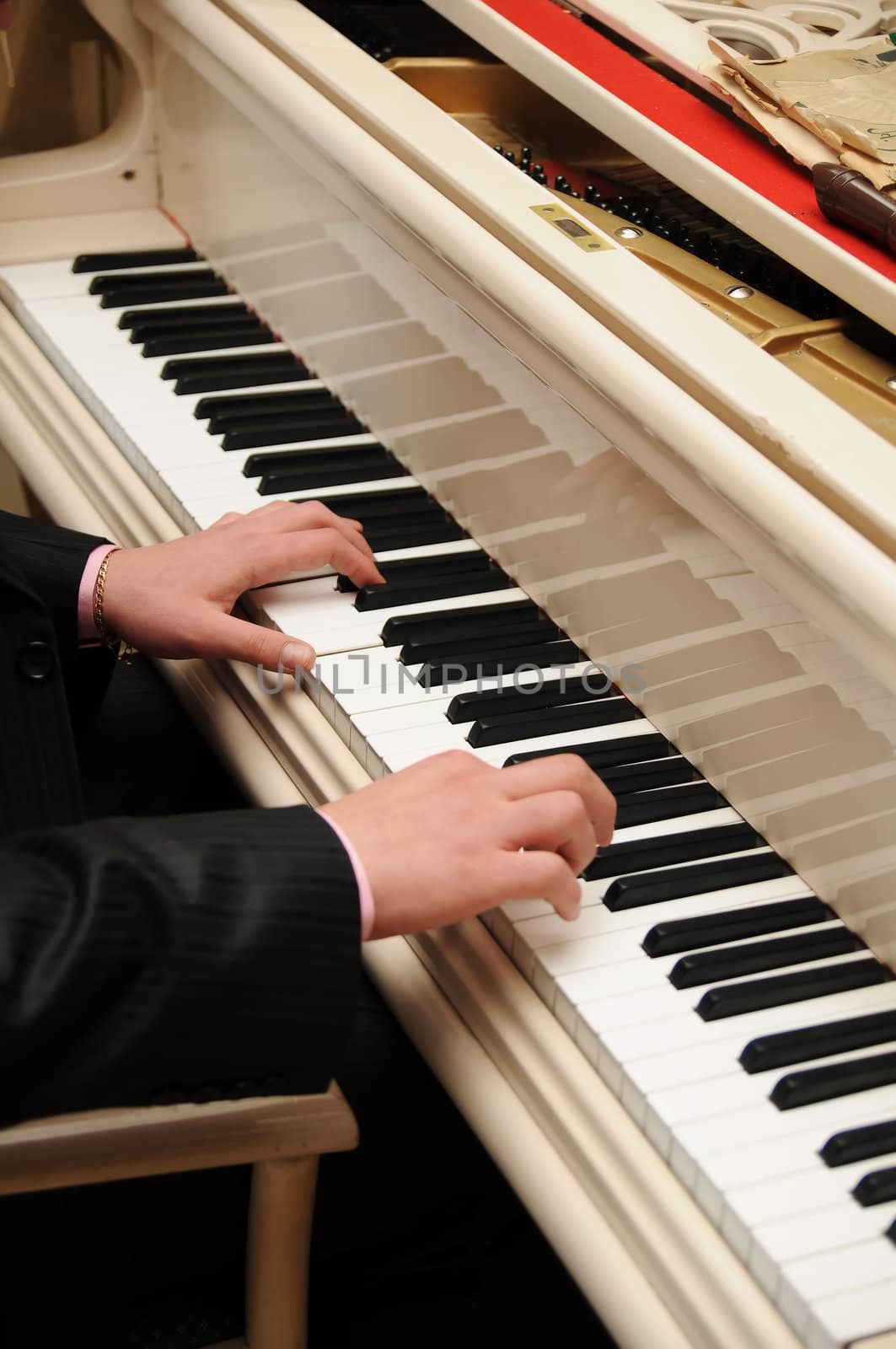 Man's hands playing piano