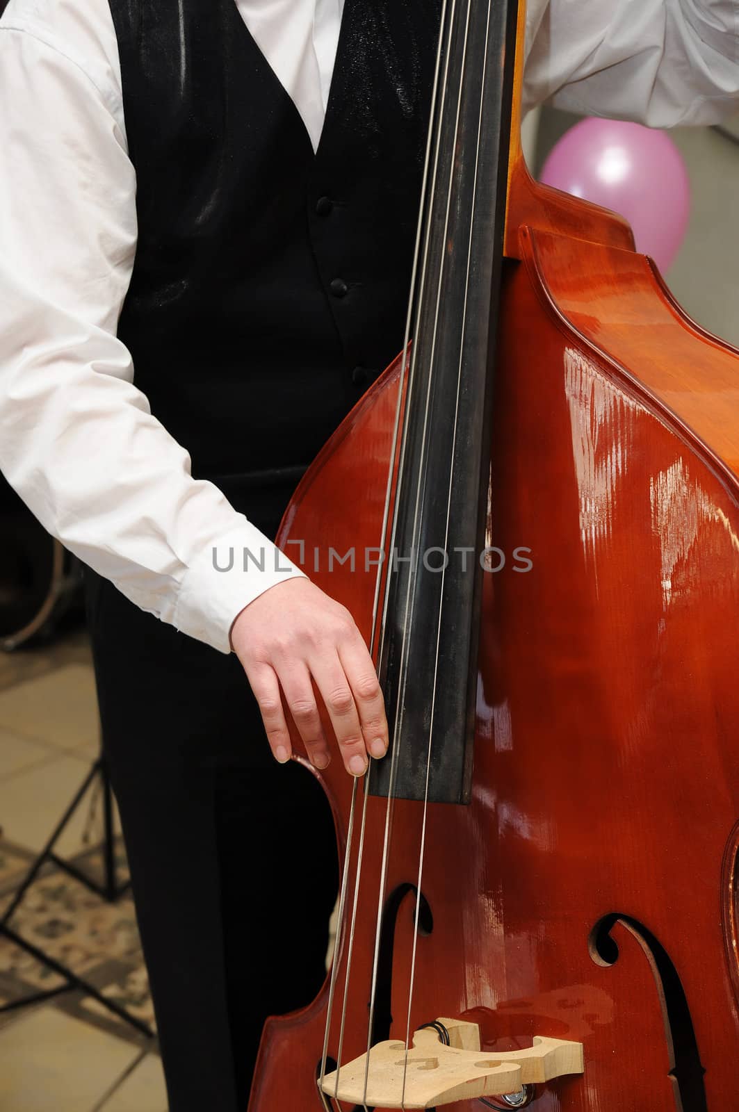 Man's hands playing contrabass