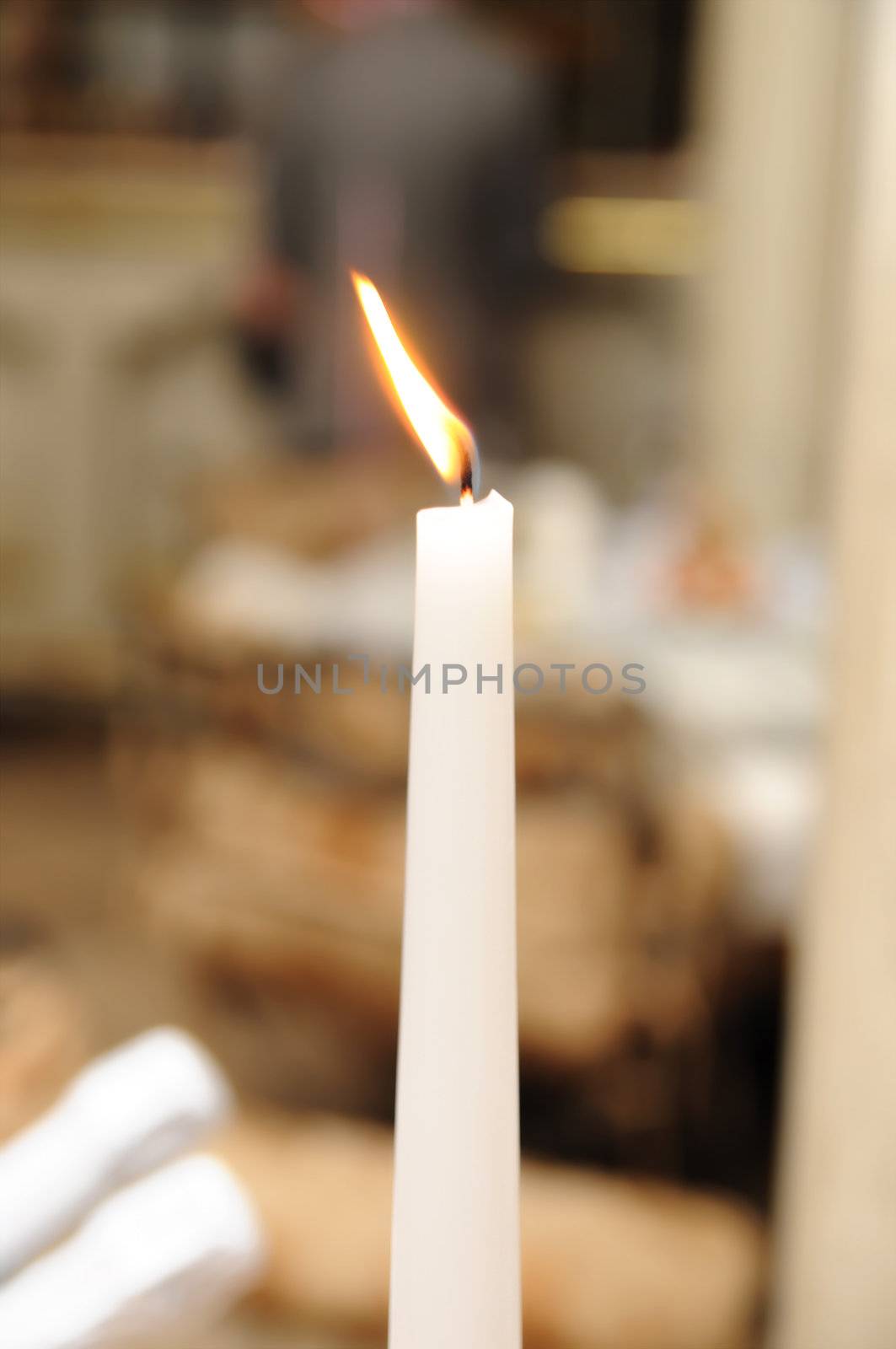 Long candle with fire burning