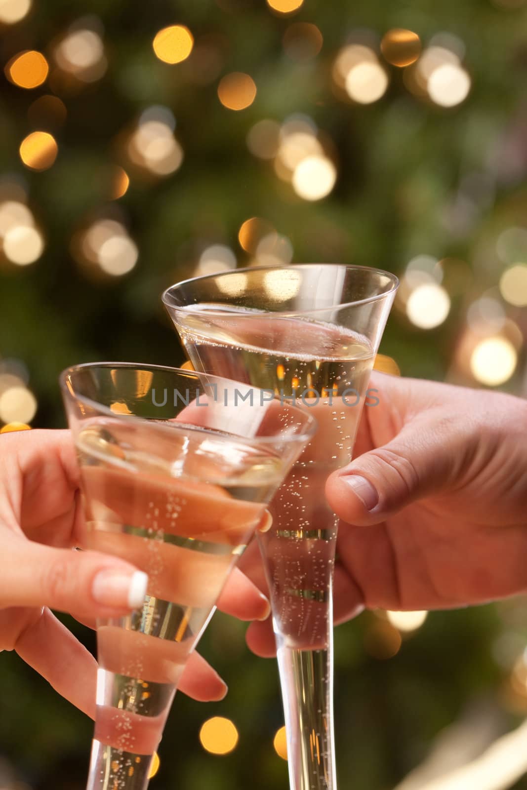 Man and Woman Toasting Champagne in Front of Decor and Lights.