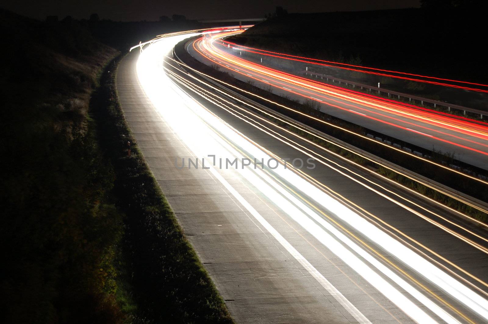highway at night with car traffic and lights