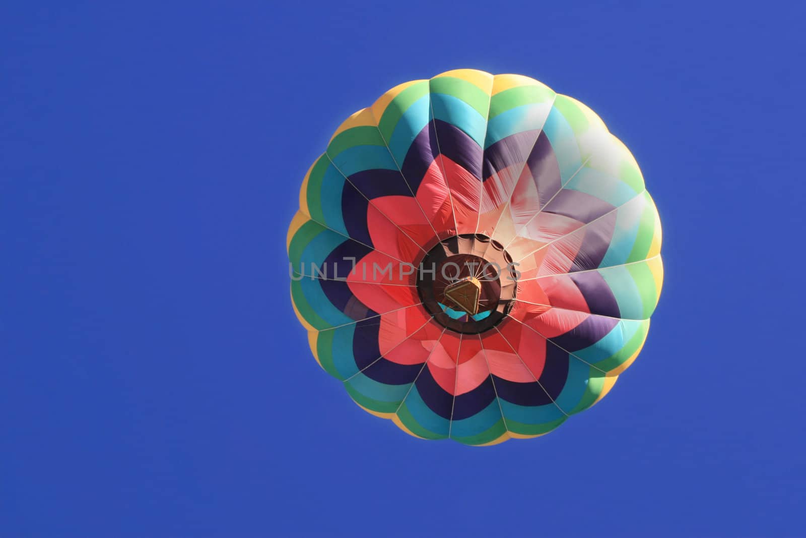 Hot air balloon ascending into perfectly blue sky during 2007 Albuquerque Balloon Fiesta