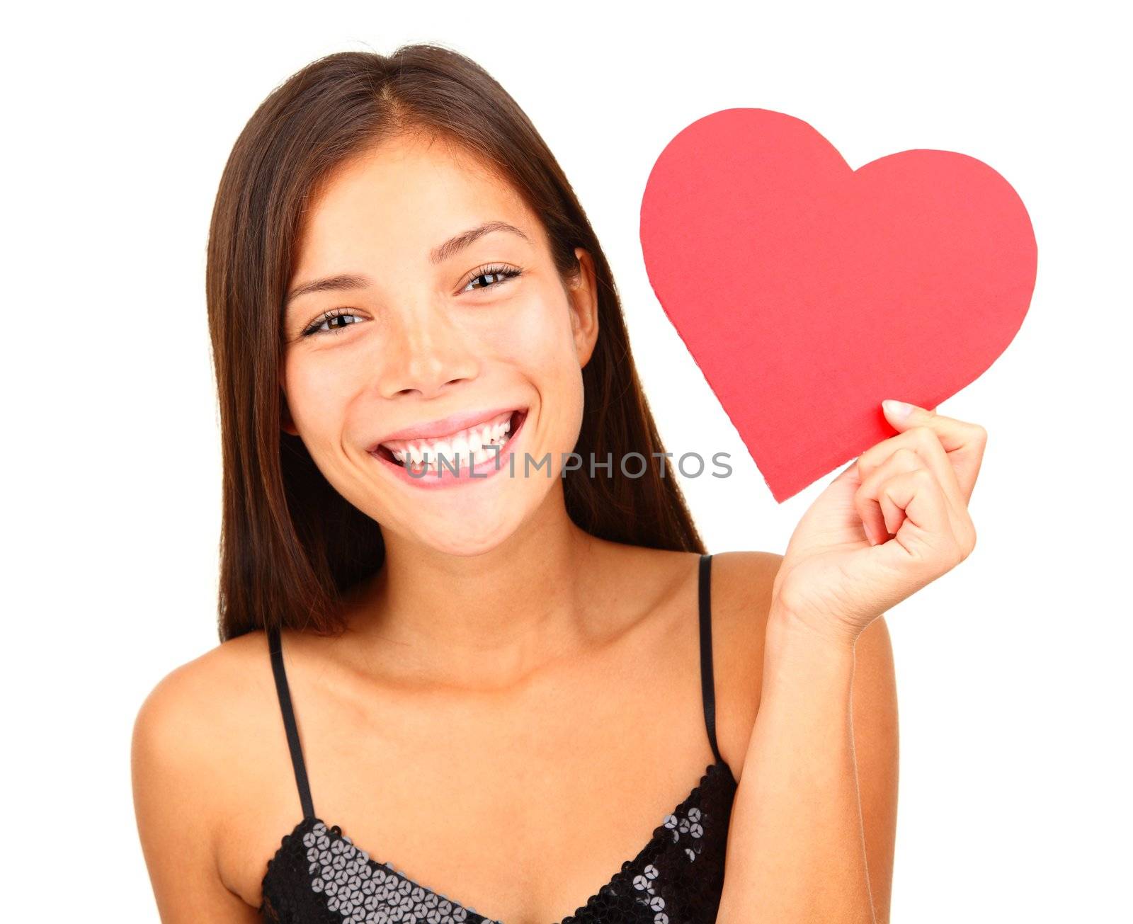 Woman holding Valentines Day heart sign with copy space. Beautiful mixed race asian / caucasian model isolated on white background. 
