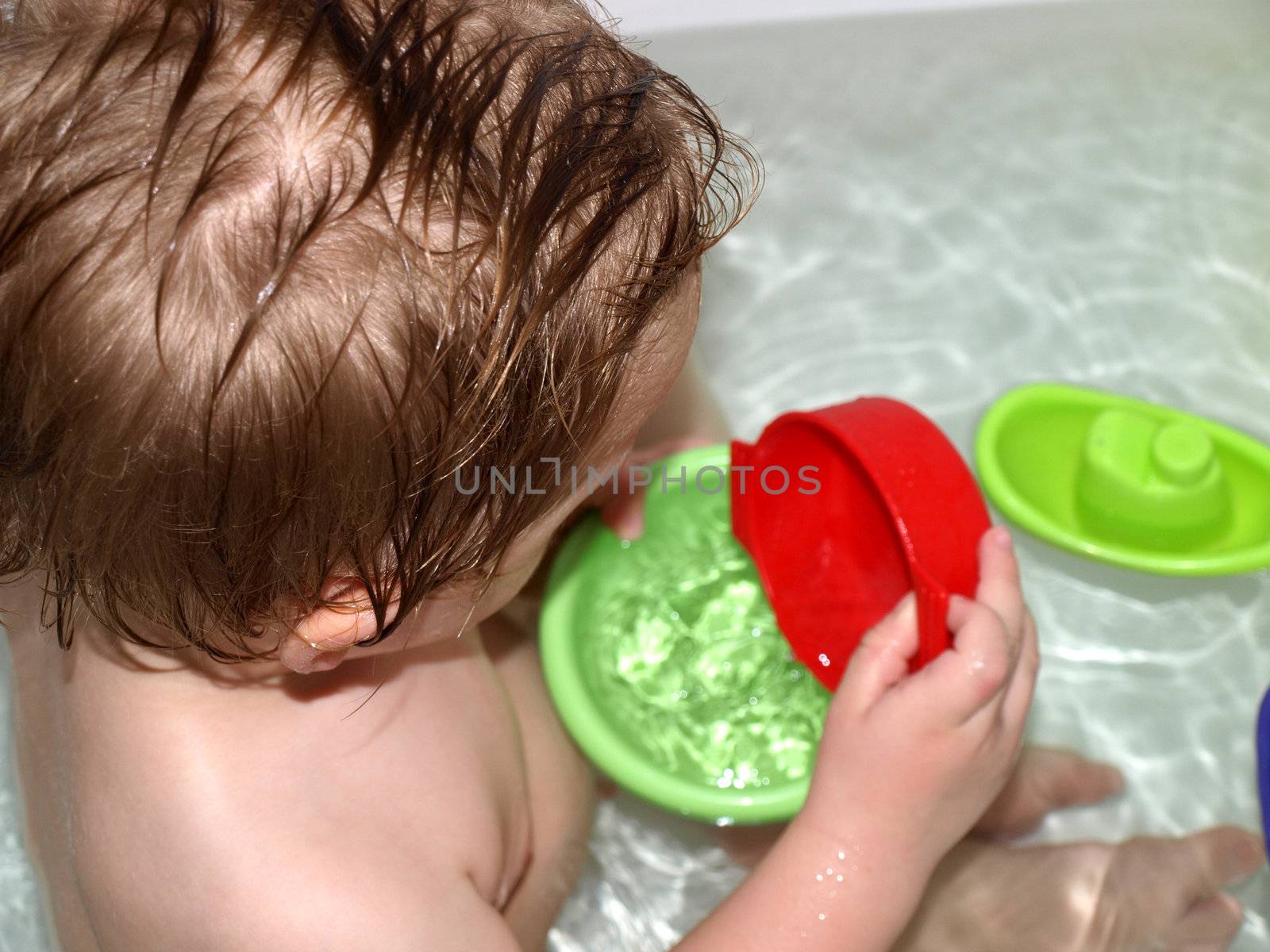 child playing in bath