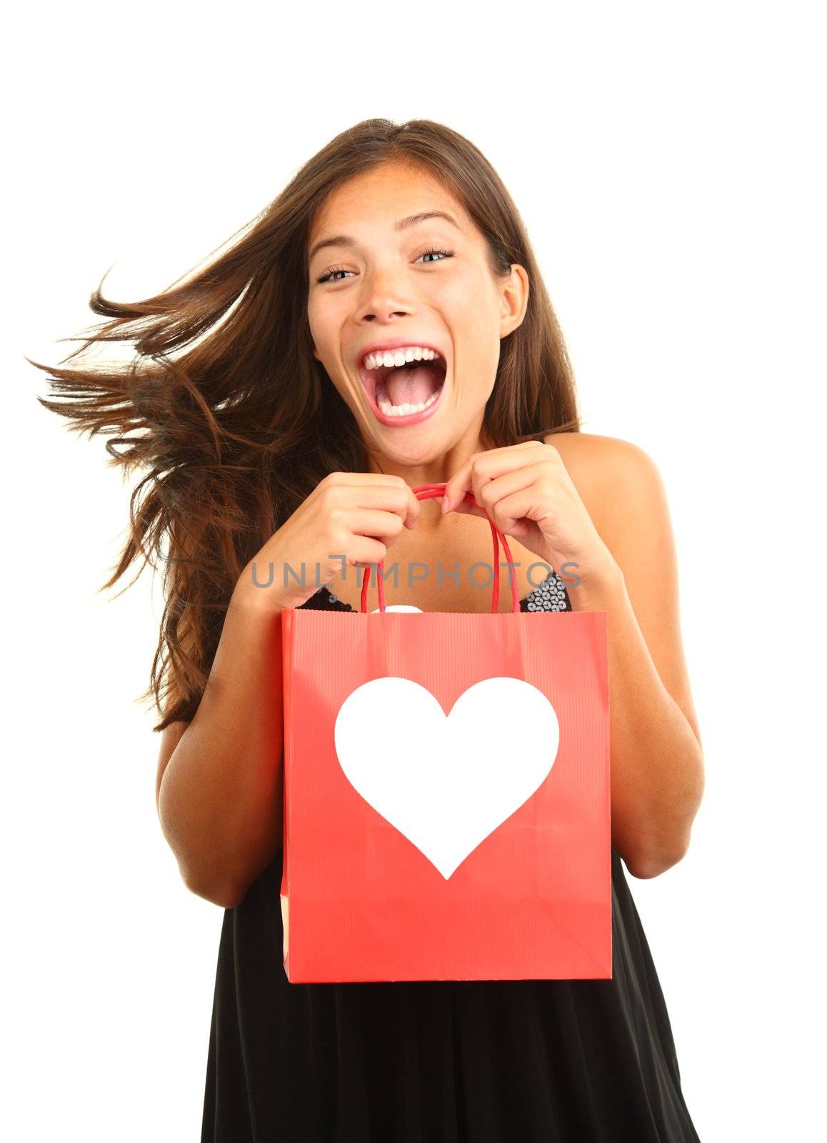 Valentines day woman very happy and excited for her gift / present. Beautiful mixed race asian / caucasian model isolated on white background. 