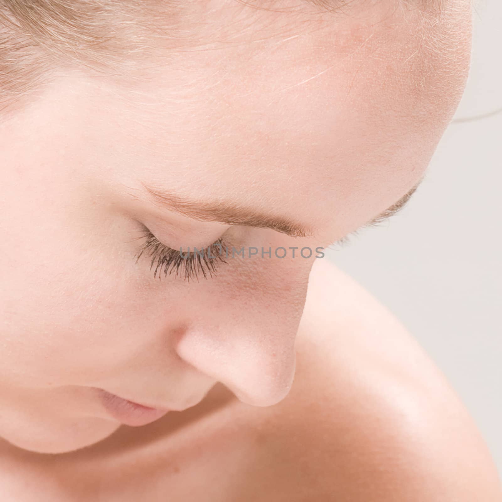 Studio close up portrait of a beautiful woman in thoughts