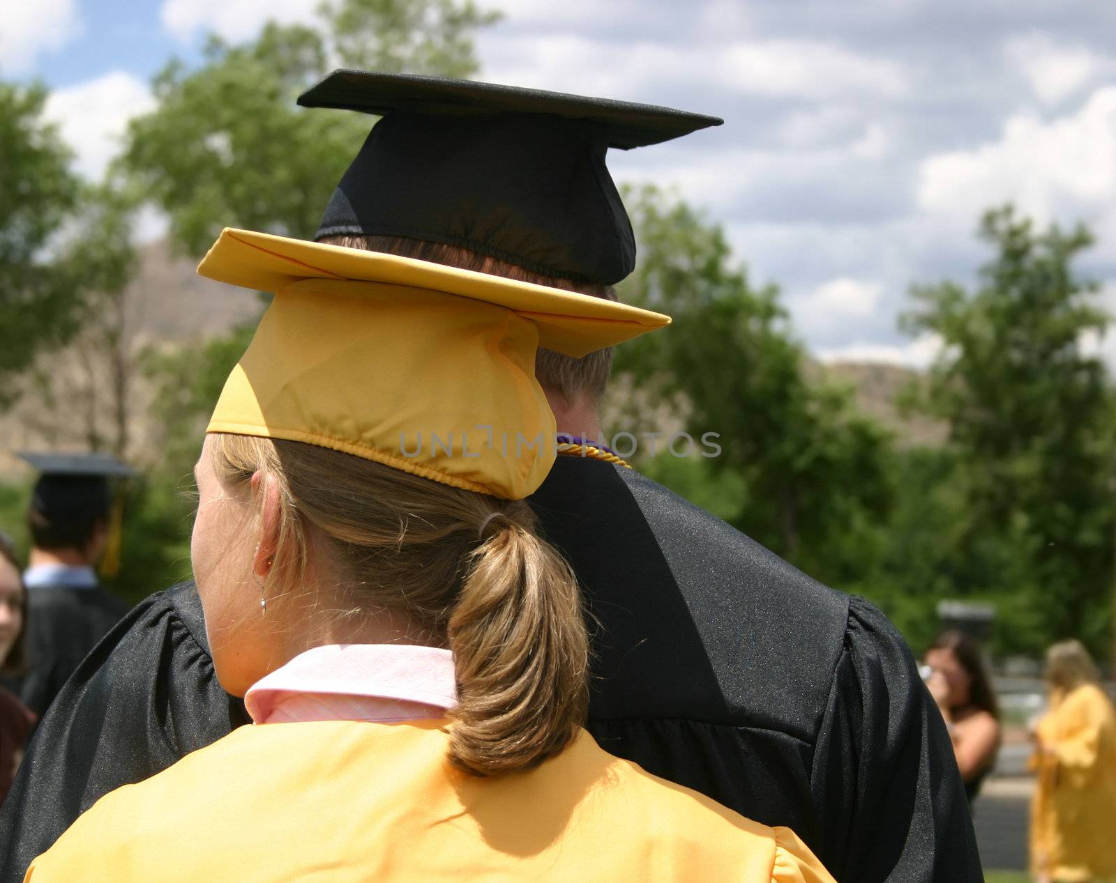 Attractive young graduating couple looking to the future