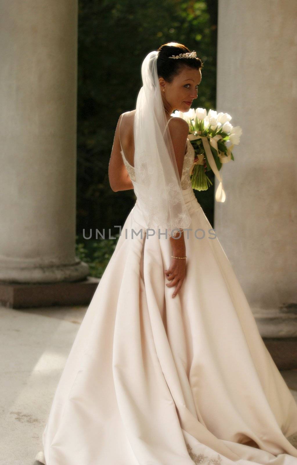 Beautiful bride with bouquet in park. Easy blur