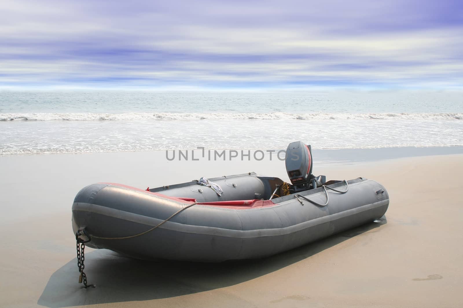 Beached inflatable boat with ocean waves in background