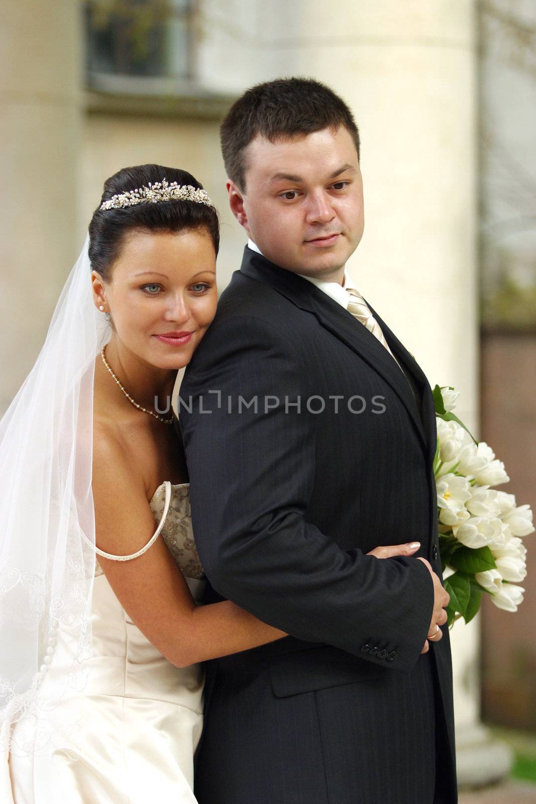 Beautiful the bride and the groom in autumn park