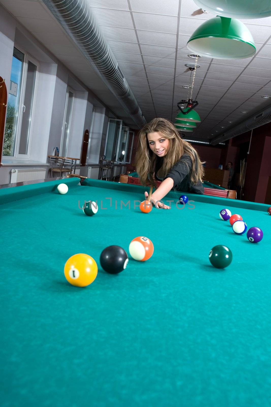 Young girl in short skirt playing snooker