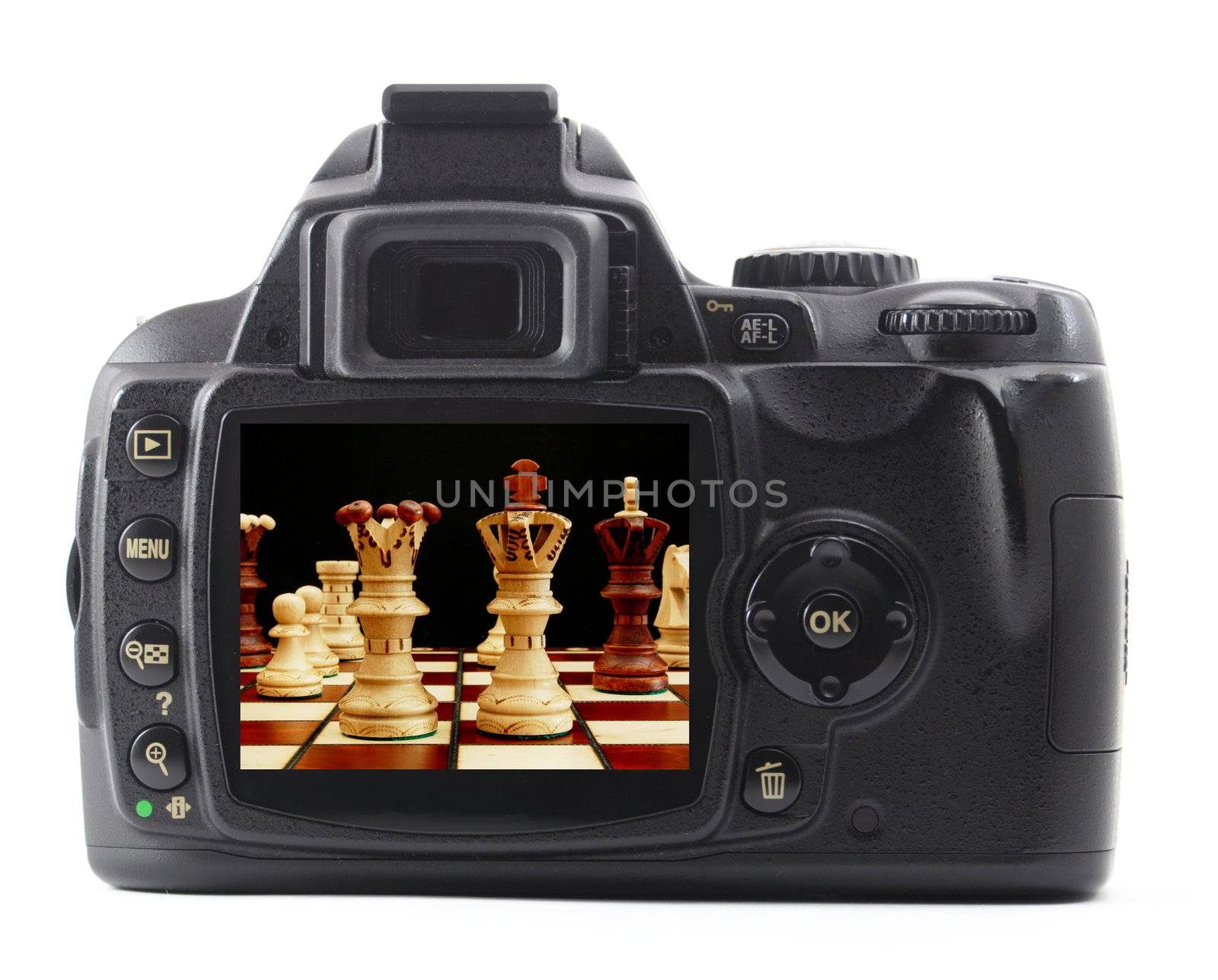 digital camera and chess pieces isolated on white background