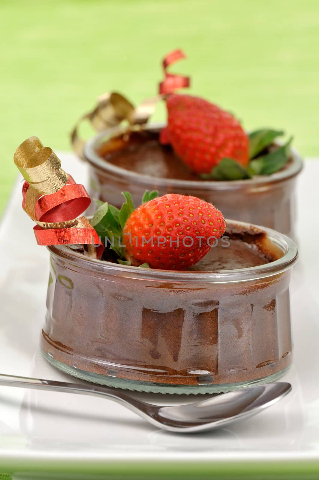 Festive chocolate mousse decorated with a strawberry and ribbons