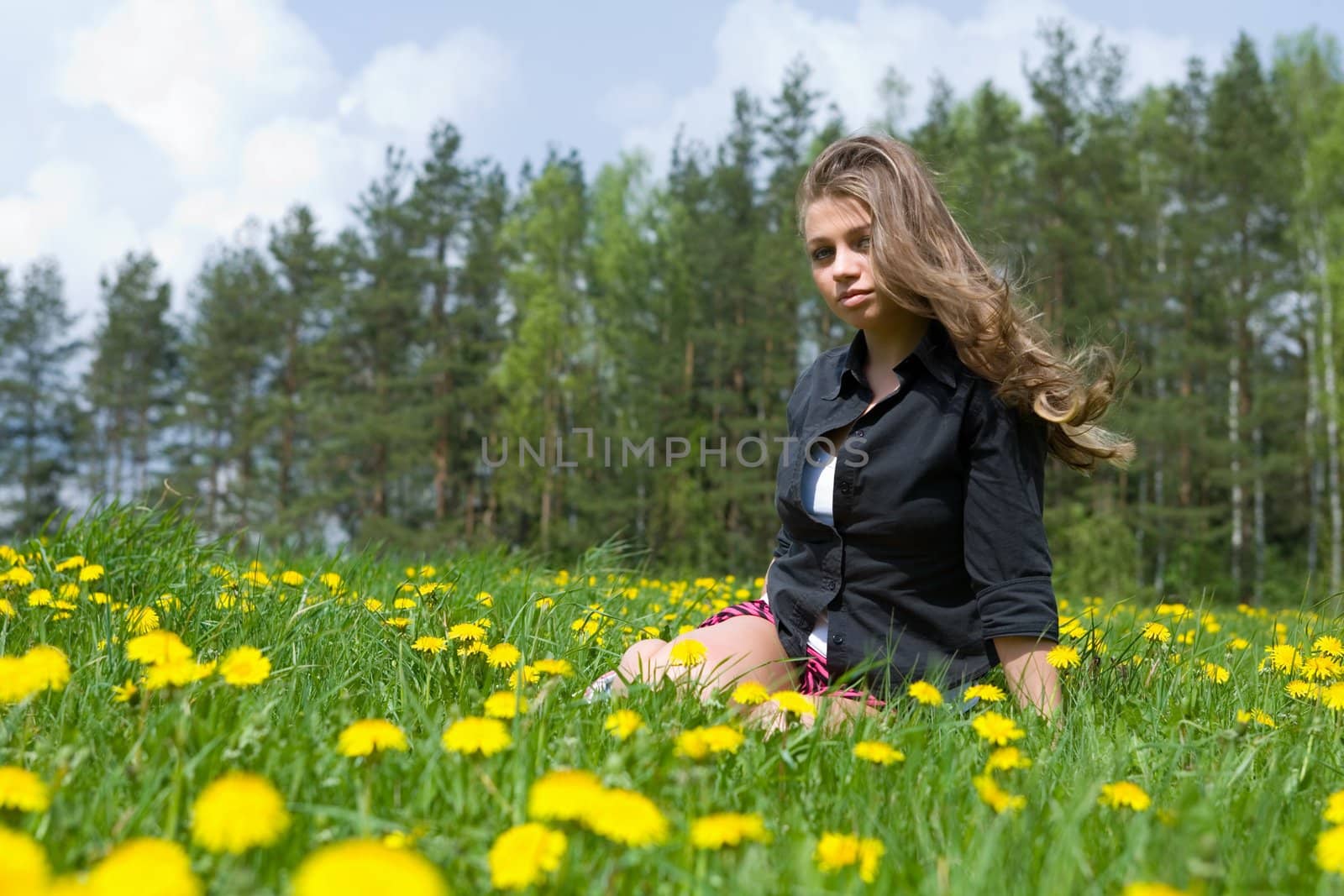  Young girl in short skirt on dandelion field