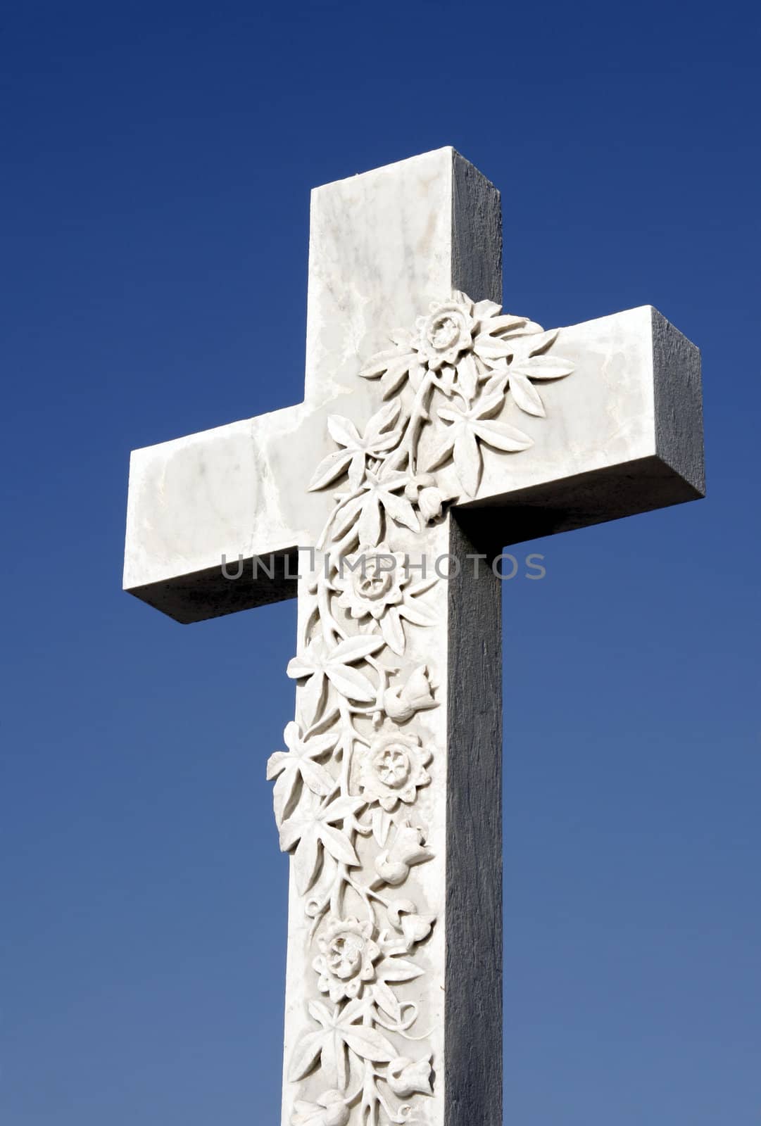 White Grave Stone Cross In Front Of Clear Blue Sky