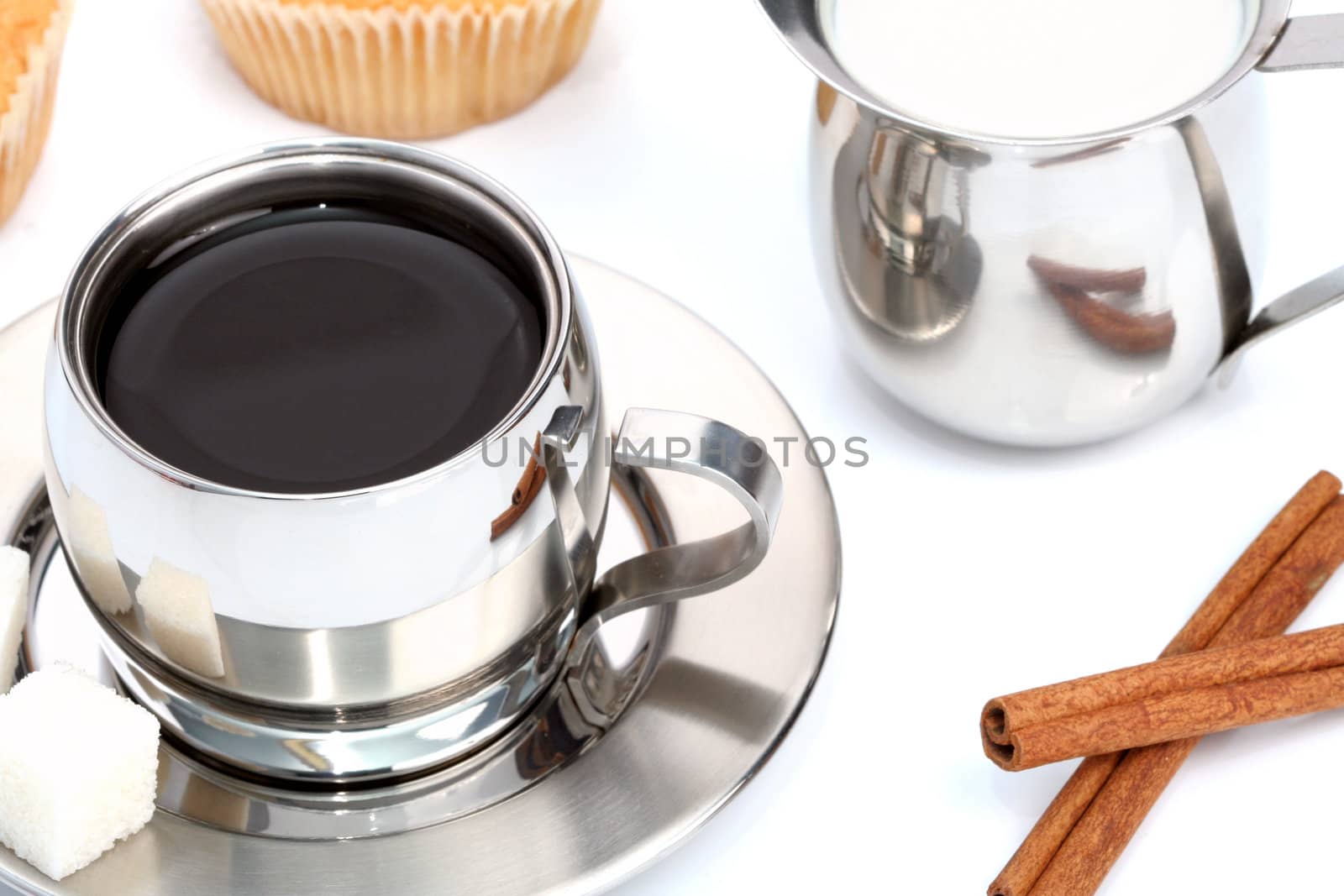 Cup of black coffee with muffin, milk and cinnamon 1