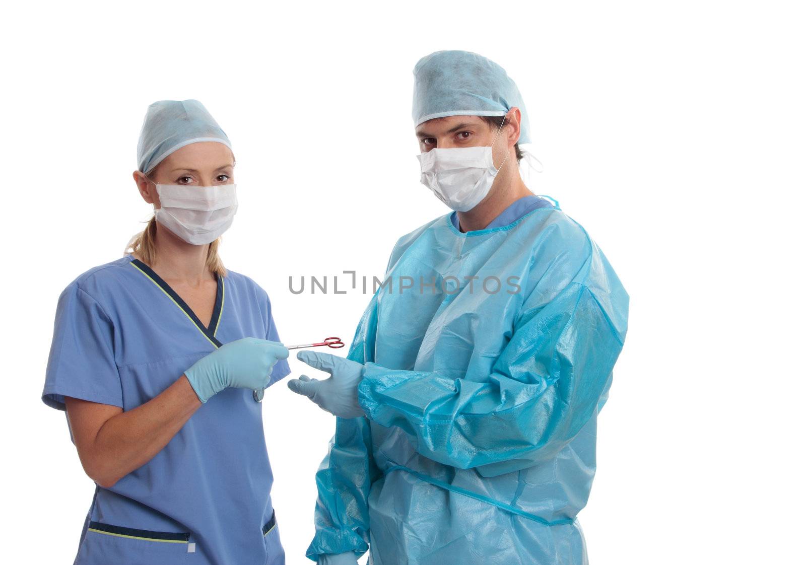 Hospital medical staff dressed  in scrubs uniform using surgical instruments.  Space for copy.